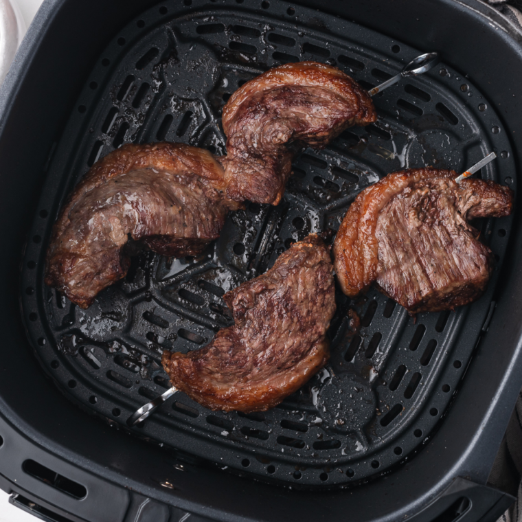 Juicy Copycat Fogo de Chão Picanha cooked to perfection in an air fryer basket.