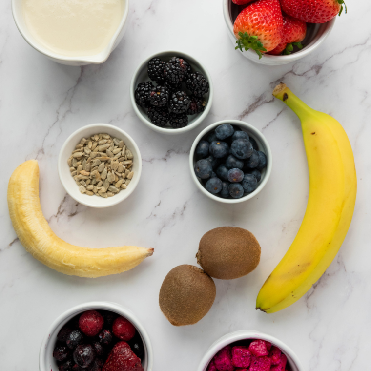 Ingredients needed for Ninja Creami Dragonfruit Yogurt Smoothie Bowl on kitchen table.