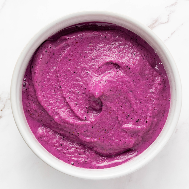 Bright and creamy Ninja Creami Dragonfruit Yogurt Smoothie Bowl topped with fresh pineapple, berries, and seeds for a delicious and healthy treat.