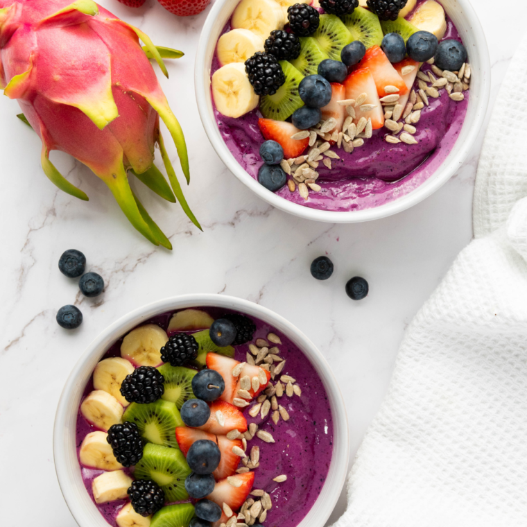 Colorful and refreshing Ninja Creami Dragonfruit Yogurt Smoothie Bowl topped with fresh berries and pineapple chunks.