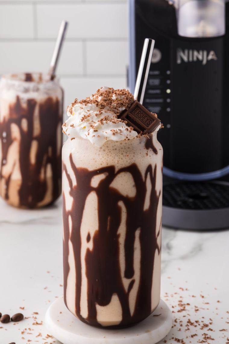 Ninja Slushi Caramel Frappuccino topped with whipped cream and chocolate drizzle.