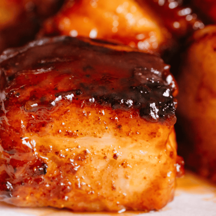 Ninja Woodfire Pork Belly Bites with steak rub, butter, brown sugar, and barbecue sauce, perfectly smoked and tender.