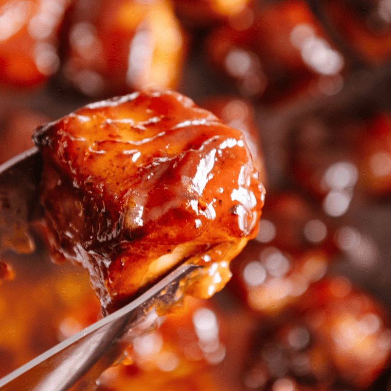 Close-up of tender, smoky Ninja Smoked Pork Belly Burnt Ends coated in a rich, caramelized glaze.