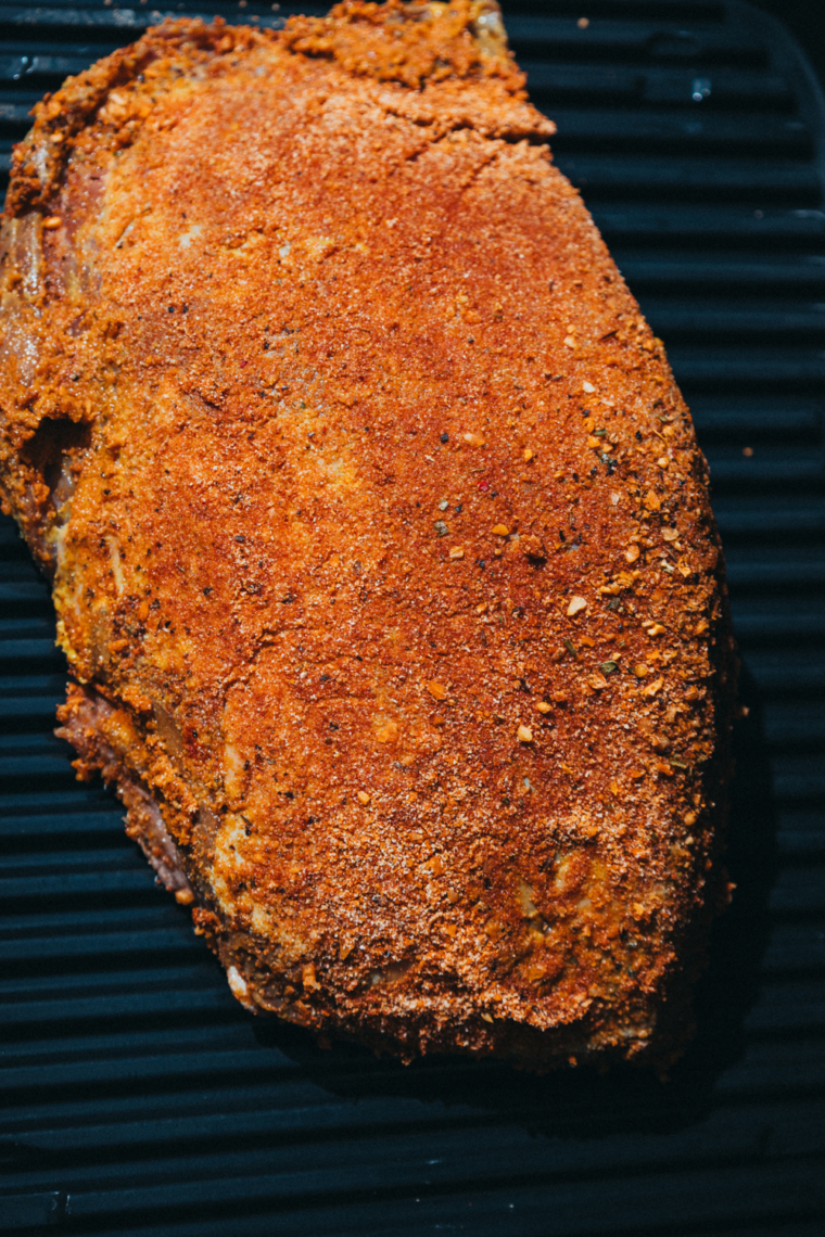 Combining and applying spices: Mixing paprika, garlic powder, and garlic and herb seasoning before coating the brisket.