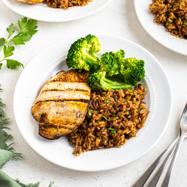 Step-by-step photos showing how to make Texas Roadhouse Seasoned Rice, a buttery and flavorful side dish seasoned with parsley, paprika, and garlic.