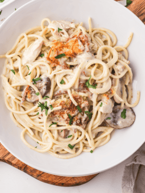 "A plate of creamy Air Fryer Chicken Tetrazzini topped with golden, crispy breadcrumbs and fresh parsley."