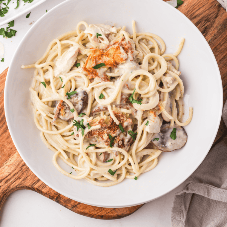 A plate of creamy Air Fryer Chicken Tetrazzini topped with golden, crispy breadcrumbs and fresh parsley.