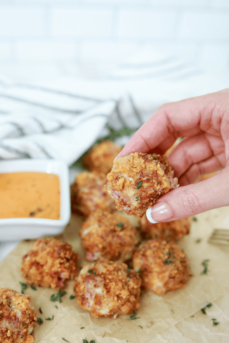 Golden, crispy Air Fryer Reuben Fritters served with Thousand Island dressing and fresh thyme.