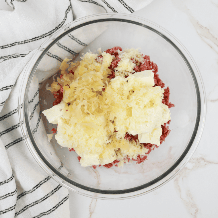 Mix cooked corned beef, cream cheese, Swiss cheese, and sauerkraut in a large bowl until well combined.