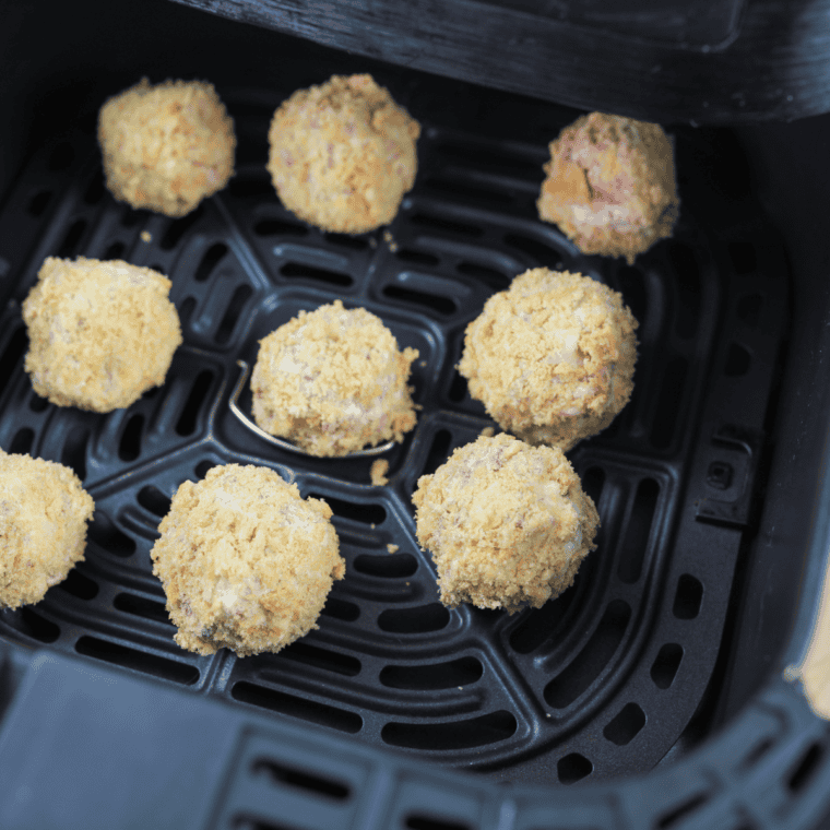 Place fritter balls in air fryer basket, space them evenly, spray with cooking spray, and air fry at 390°F for 6-8 minutes, flipping halfway.