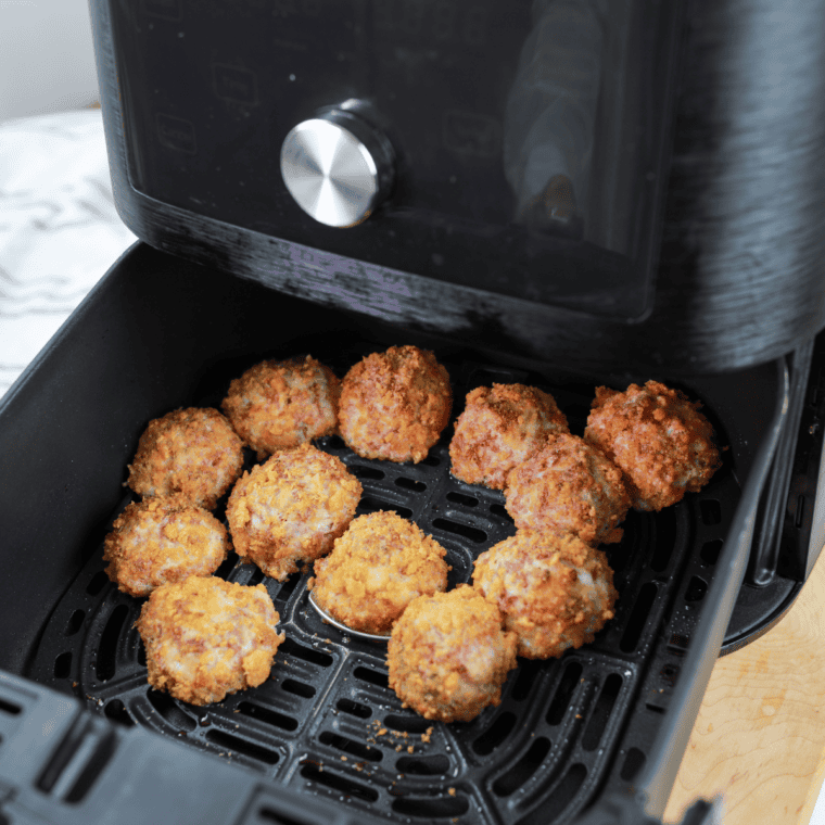 Golden, crispy Air Fryer Reuben Fritters with corned beef, Swiss cheese, and sauerkraut, served with Thousand Island dressing.