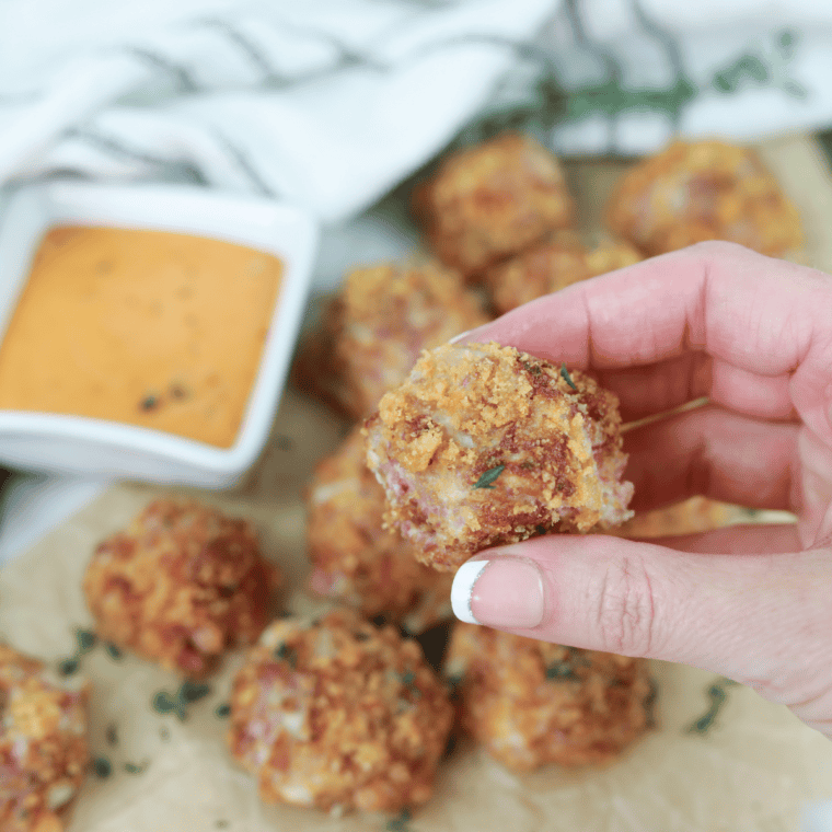 Air Fryer Reuben Fritters made with corned beef, Swiss cheese, and sauerkraut, ready to be served with Thousand Island dressing.