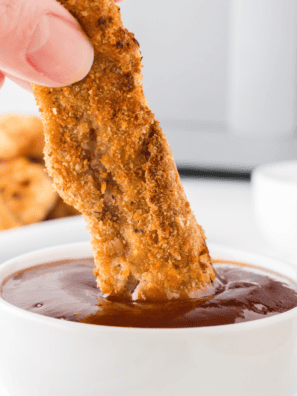 Crispy, golden-brown Air Fryer Steak Fingers served on a plate with dipping sauce.