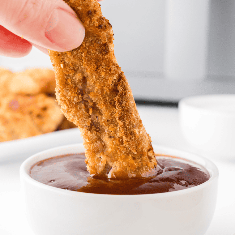 Crispy, golden-brown Air Fryer Steak Fingers served on a plate with dipping sauce.