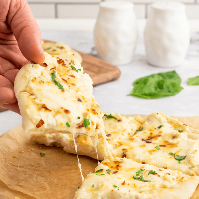 Golden, crispy Air Fryer White Pizza (Pizza Bianca) topped with ricotta, mozzarella, and fresh herbs on a wooden board.