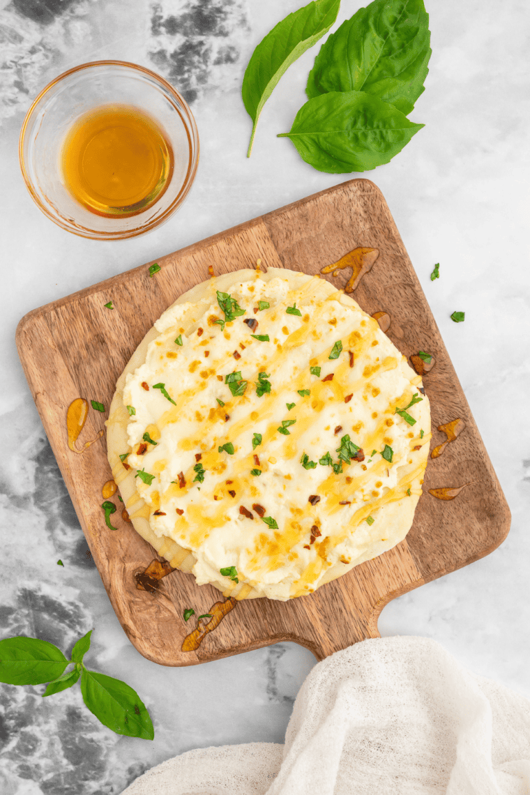 Air Fryer White Pizza (Pizza Bianca) with a golden, crispy crust topped with melted cheeses and fresh basil.