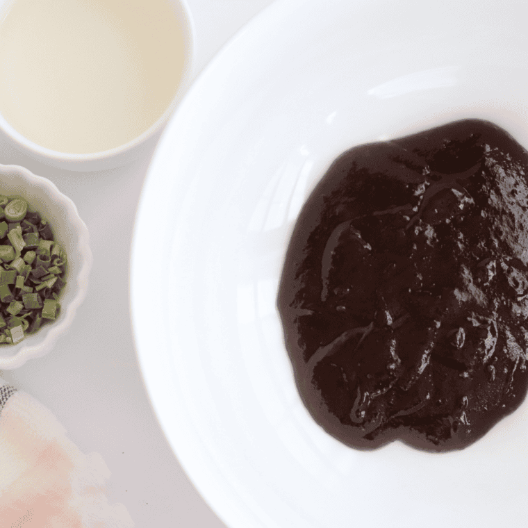 Cooking onions, garlic, and tomato paste in a saucepan with vegetable oil for Ancho BBQ sauce.