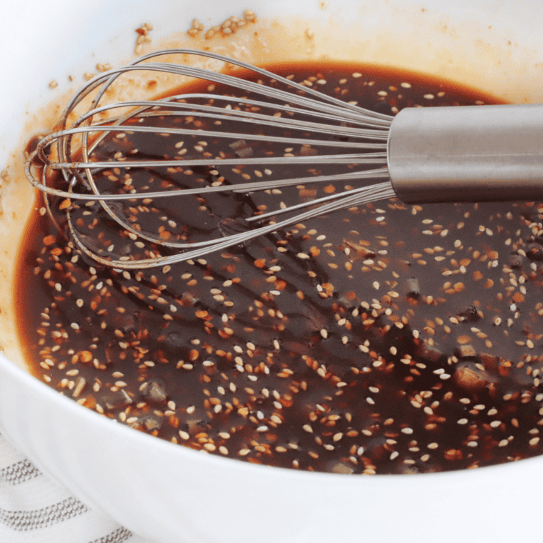 Adding spices and simmering Ancho BBQ sauce to thicken.