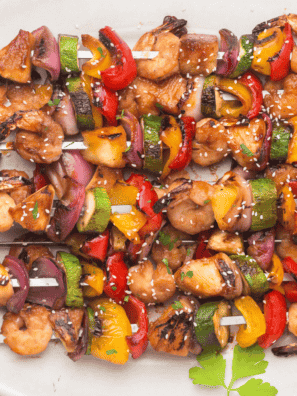 Grilled Blackstone Teriyaki Shrimp with a glossy glaze and garnished with green onions.