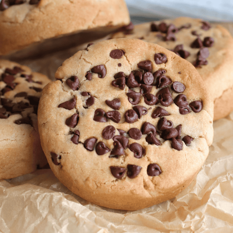 Brown Butter Peanut Butter Cookies with chocolate chips and a flaked salt topping on a cooling rack.