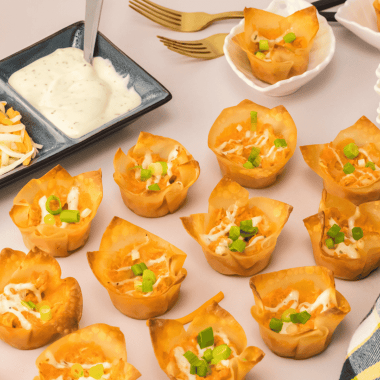 Smooth and creamy Buffalo Ranch Dressing in a bowl, drizzled with buffalo sauce and garnished with herbs.