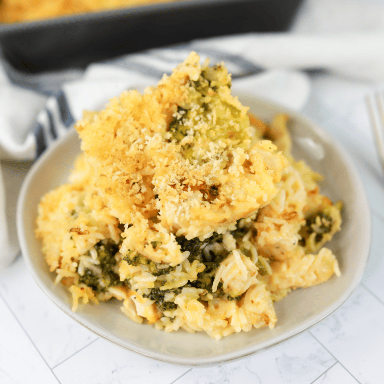 Cheddar’s Broccoli Cheese Casserole with melted cheese and a golden, buttery cracker topping, served in a baking dish.