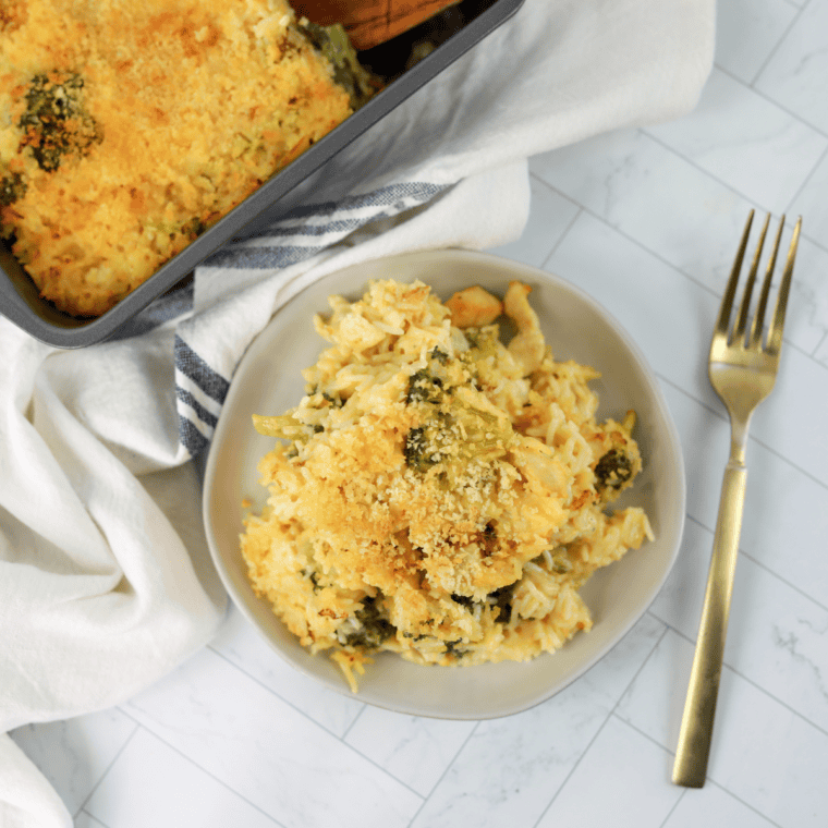 Cheddar’s Broccoli Cheese Casserole with creamy cheese and a crispy golden cracker topping in a baking dish.