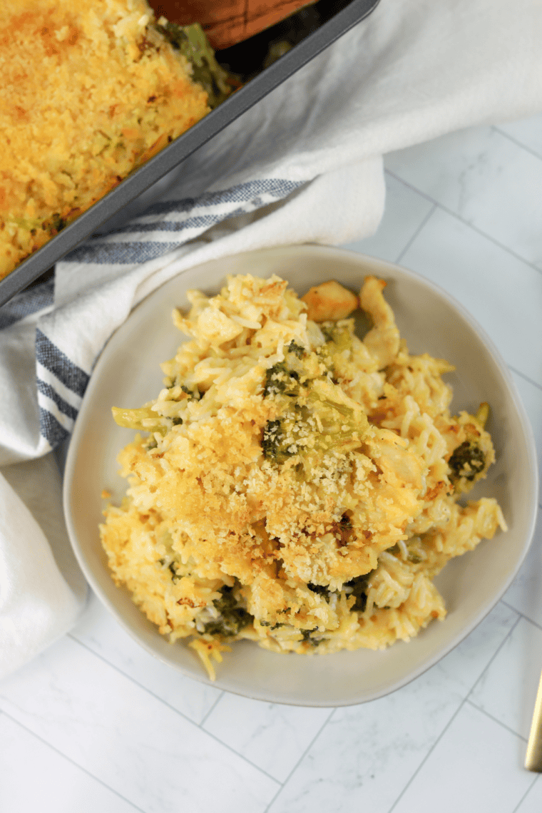 Cheddar’s Broccoli Cheese Casserole with melted cheese and a crispy cracker topping in a baking dish.