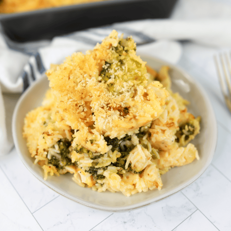 Cheddar’s Broccoli Cheese Casserole with melted cheese and a crispy cracker topping, served in a baking dish.