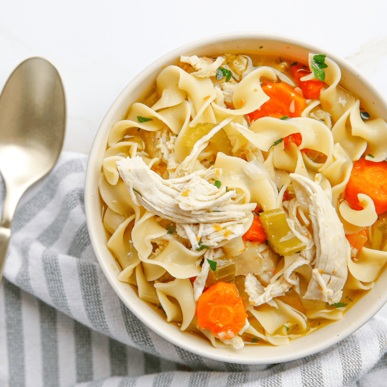 A warm bowl of homemade Chick-fil-A Chicken Noodle Soup with tender chicken, noodles, and vegetables in a savory broth.