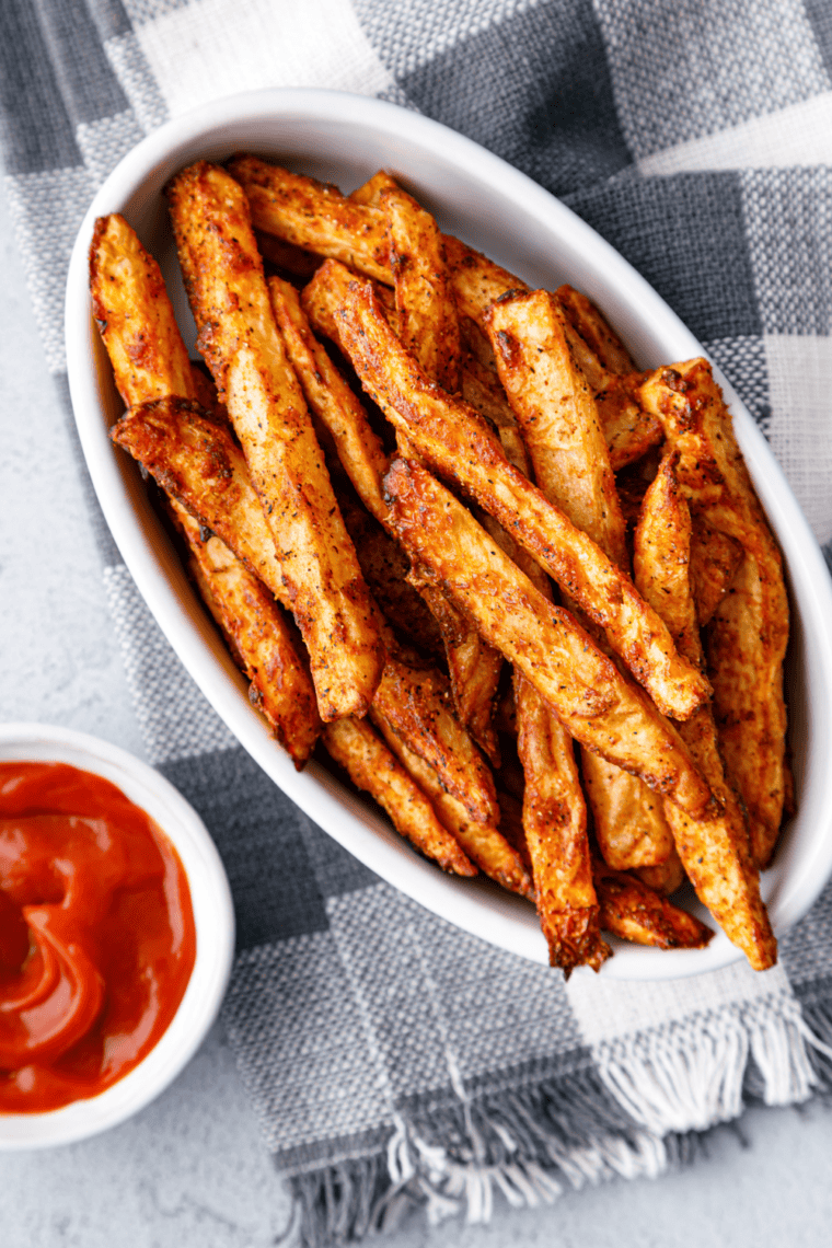 A plate of golden, crispy Copycat Checkers Seasoned Fries, perfectly seasoned and air-fried to perfection.