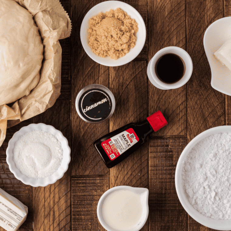 Ingredients for Copycat Cinnabon Frosting on kitchen table, wooden.