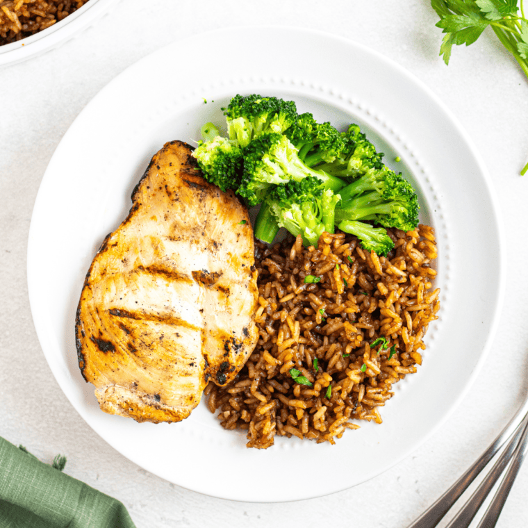 Dish of Copycat Popeyes Cajun Rice, seasoned with Cajun spices, vegetables, and savory flavors.