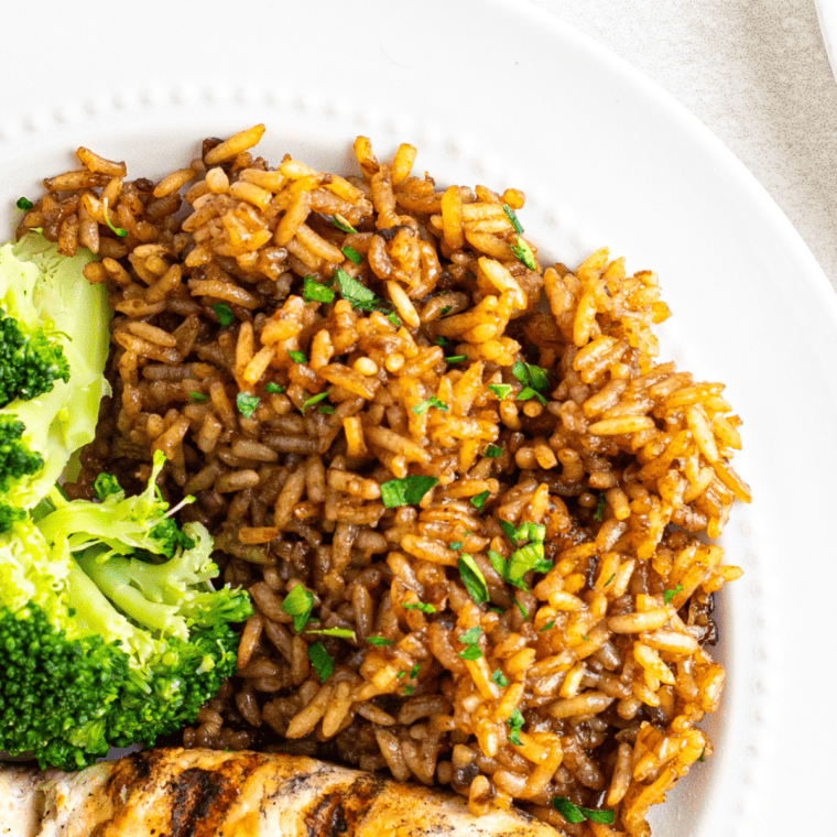 Bowl of Copycat Popeyes Cajun Rice served as a side dish with bold spices and seasoned perfectly.