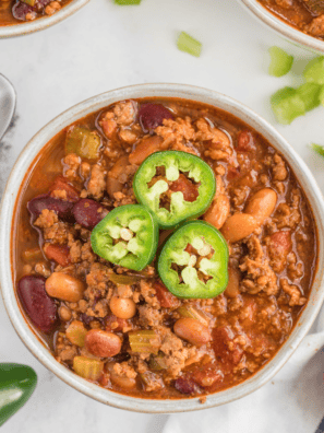 A hearty bowl of Copycat Steak ‘n Shake Chili topped with shredded cheese and served with crackers.