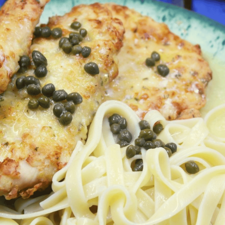 Chicken Piccata from Maggiano's: Tender chicken breast in a lemon-butter caper sauce, served with pasta and garnished with parsley.