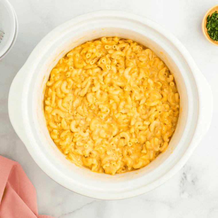 Pour macaroni and cheese mixture into crockpot, top with crushed crackers, and cook until creamy.