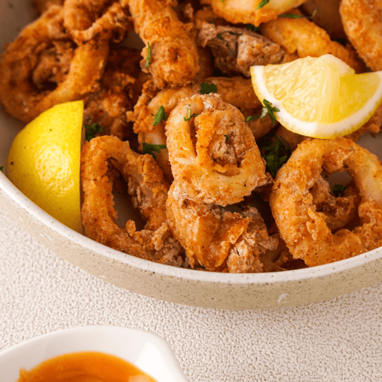 Golden, crispy Olive Garden-style calamari served with a side of marinara sauce.