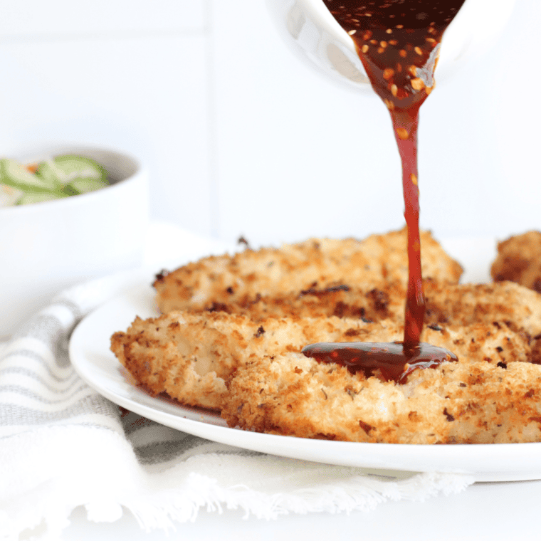 Crispy homemade Texas Roadhouse Chicken Critters served with dipping sauce on a plate.