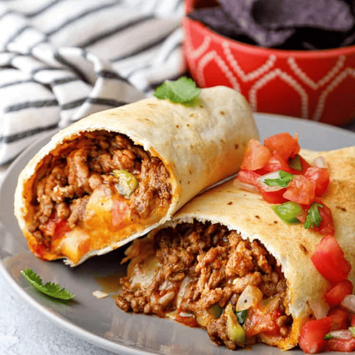 Golden crispy Air Fryer Beef Chimichangas filled with tender beef and melted cheese, served with a side of salsa.