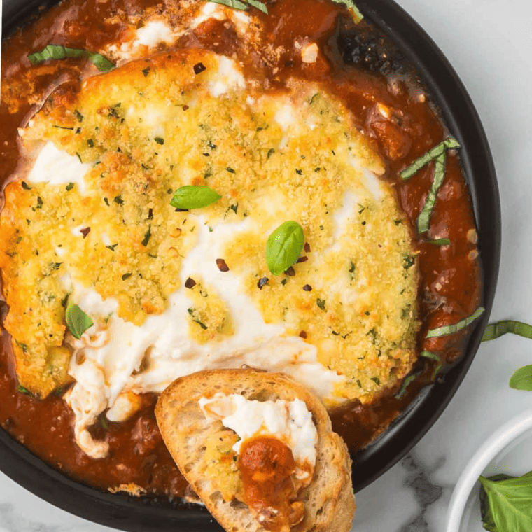 Golden, crispy Air Fryer Burrata with a melty, creamy center served with fresh basil and toasted bread.