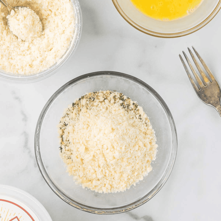 Rolling the burrata ball in a breadcrumb and Parmesan cheese mixture for a crispy coating.