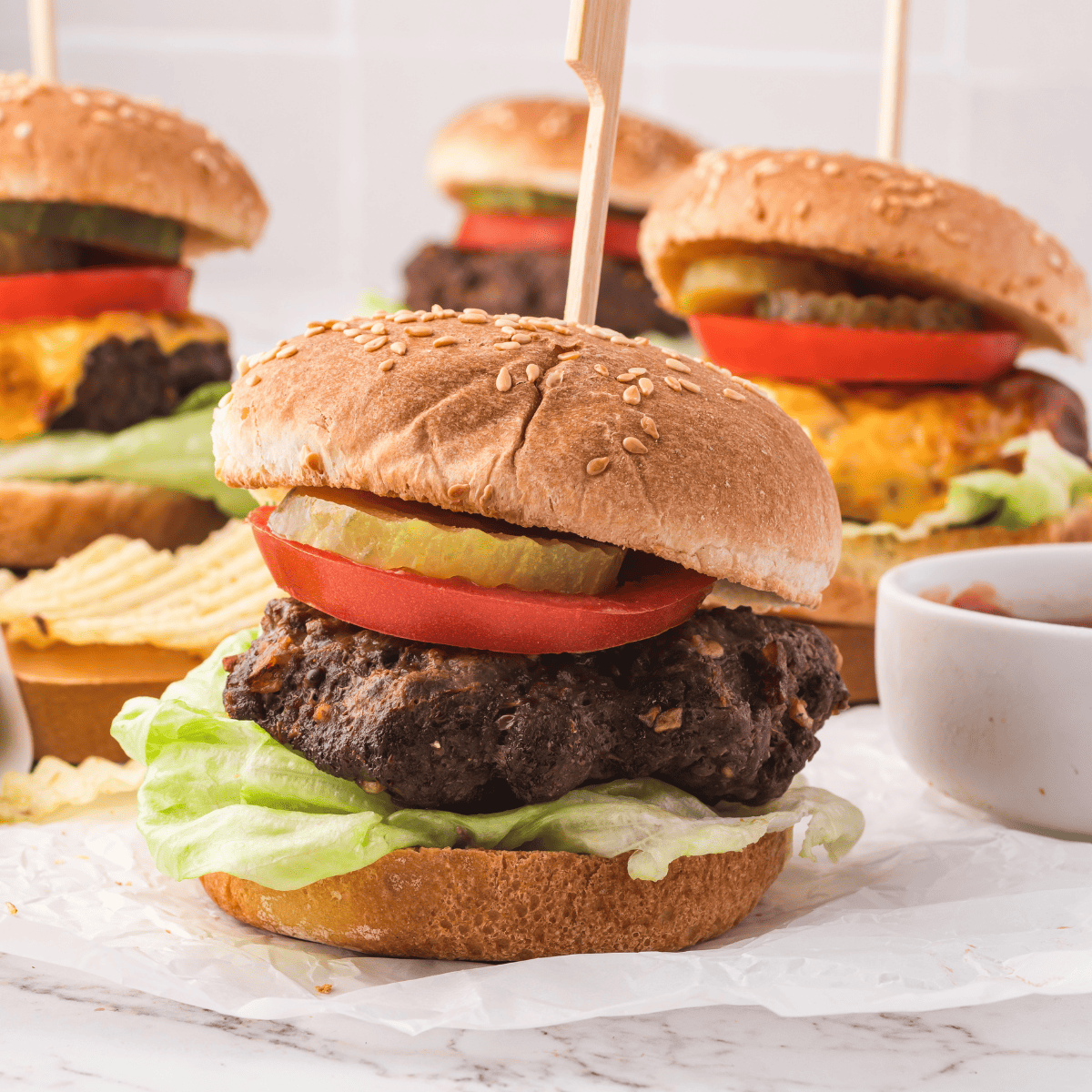 Golden brown Air Fryer Lipton Onion Soup Mix Burgers served on toasted buns with lettuce, tomato, and melted cheese.