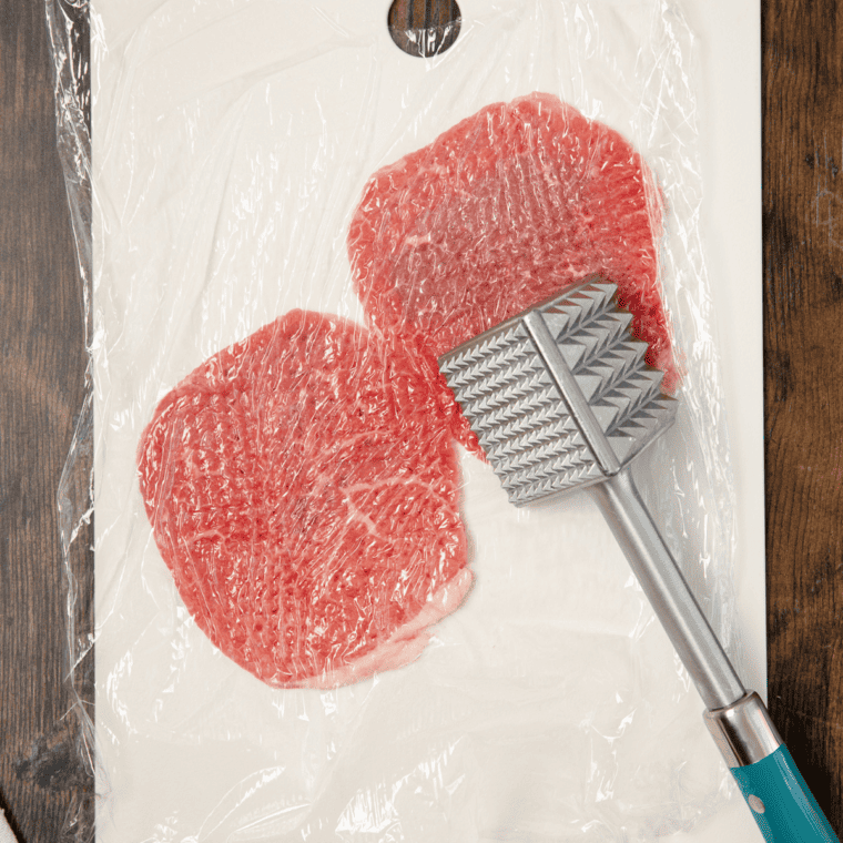 Steak cut into serving-sized pieces, tenderized with a meat mallet.