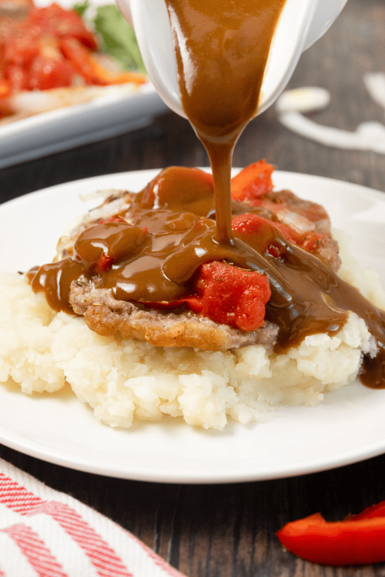 Air Fryer Swiss steak with tender beef, tomato gravy, and vegetables.