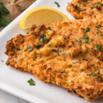 Golden and crispy Air Fryer Veal Scaloppine served with a side of vegetables.