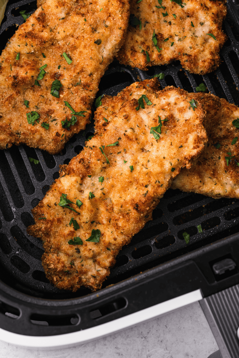 Crispy golden Air Fryer Veal Scaloppine served with vegetables, showcasing perfectly cooked veal cutlets
