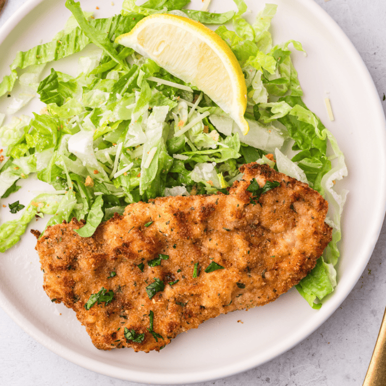 Golden, crispy Air Fryer Veal Scaloppine served with a side of vegetables.