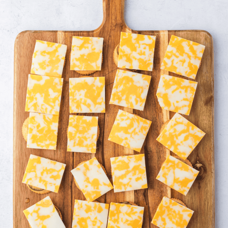 Stacked Ritz crackers with pickles and cheese ready for air frying.