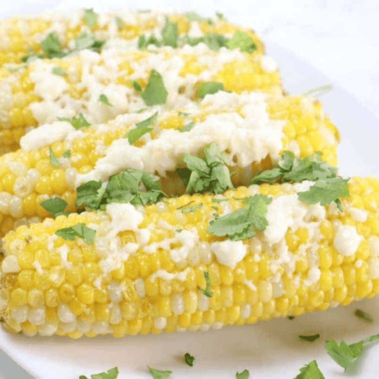 Close-up of Chili’s Roasted Street Corn, grilled to perfection and coated with creamy sauce, cotija cheese, and spices.